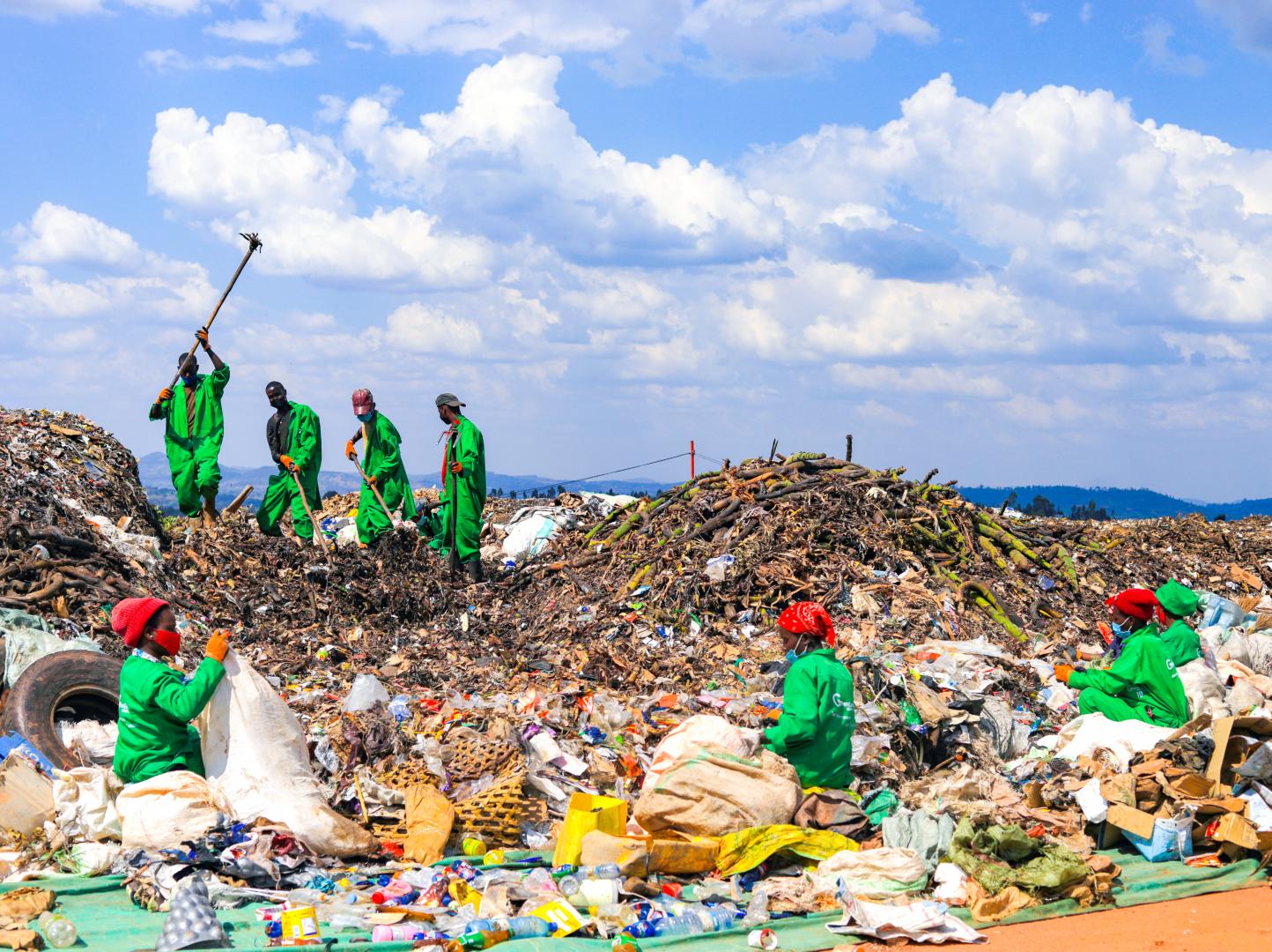 Efficiently tackling waste management together: a group of dedicated youth sorting, recycling, and disposing of waste responsibly at Green Care Rwanda Ltd, ensuring a cleaner and greener Huye.