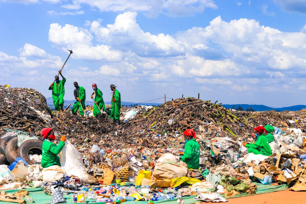 Efficiently tackling waste management together: a group of dedicated youth sorting, recycling, and disposing of waste responsibly at Green Care Rwanda Ltd, ensuring a cleaner and greener Huye.
